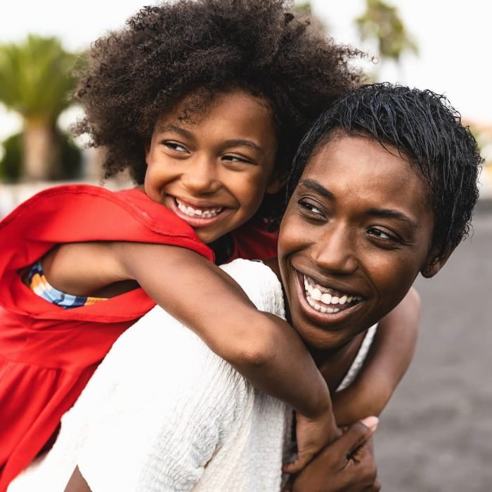 happy-african-family-having-fun-on-the-beach-during-summer-holidays-e1657706530227.jpg